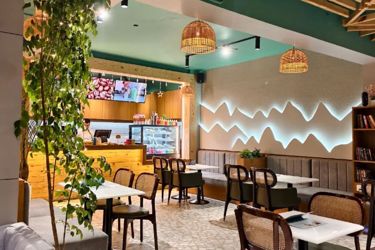 Booth seating and warm lighting inside Kafe, Taramandal, Gorakhpur